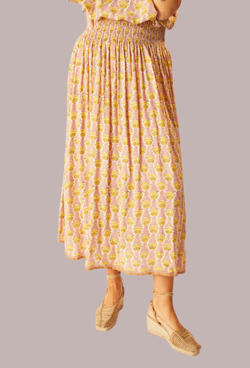 women in elastic waistband pink and yellow printed maxi skirt