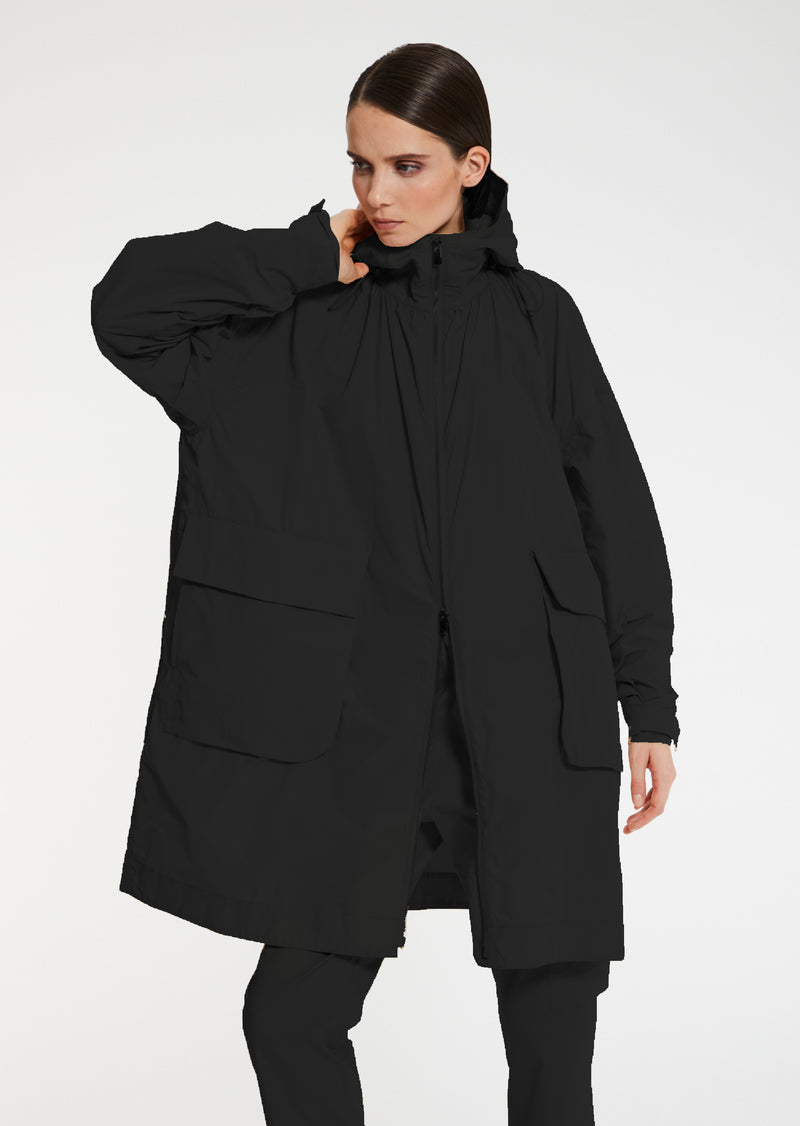 The Eden Raincoat features a large hood and two way zip front. A fabulous adjustable gathered neckline allows you to make it your own and switch it up day-to-day. Water-repellent for those wet days - oversized for perfect layering. 