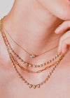 The Poppy Two-Stone Pendant is classic staple in any neck stack. An everyday essential, Poppy Two-Stone Pendant delicately hangs on the neck by an 18 inch adjustable ball chain. Handcrafted in 18-karat gold and featuring 0.40tcw of pear and marquise diamonds. 