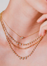 The Poppy Two-Stone Pendant is classic staple in any neck stack. An everyday essential, Poppy Two-Stone Pendant delicately hangs on the neck by an 18 inch adjustable ball chain. Handcrafted in 18-karat gold and featuring 0.40tcw of pear and marquise diamonds. 