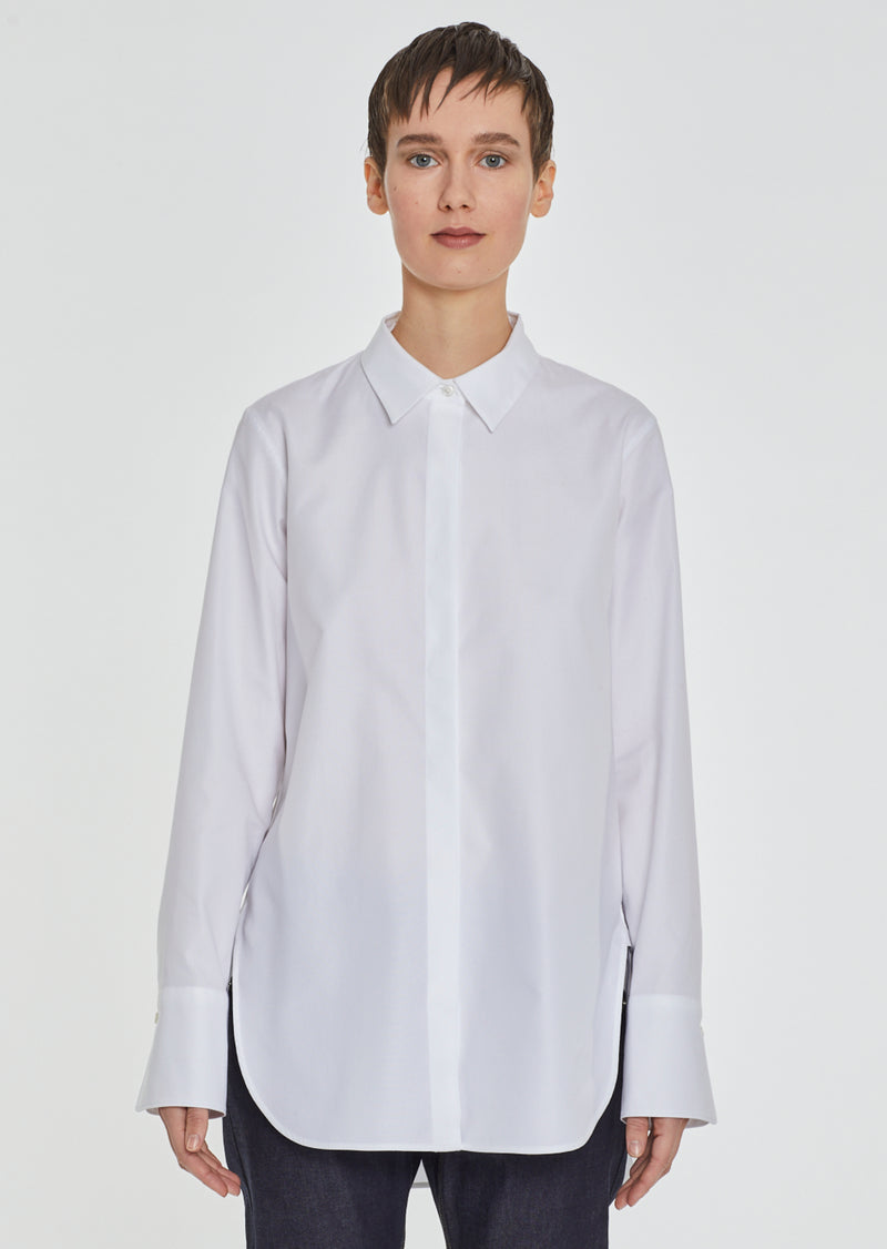 FABULOUS Button Down! Elevate your wardrobe with the Jazz Icon Button Down. Crafted from beautiful Egyptian cotton, this women's button down features a high low hem. Perfect for adding a touch of sophistication to any outfit.