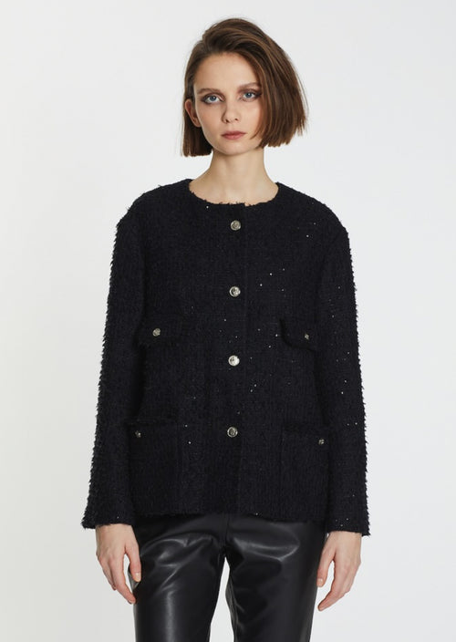 An elegant and timeless piece designed to elevate any outfit, this little tweed blazer is the best! Lis Lareida's must have Black Pearl Tweed jacket with a touch of subtle sparkly sequins, front pockets with raw edge details.