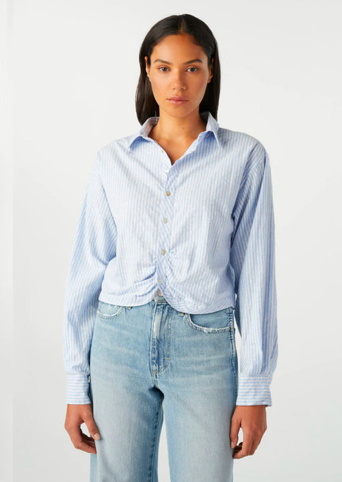 Introducing the AMO Anna Mae Shirt in Sky Blue: a refined twist on a classic button-up. Featuring feminine tailoring and a gathered waist, this cropped top exudes sophistication and pairs perfectly with any outfit. 