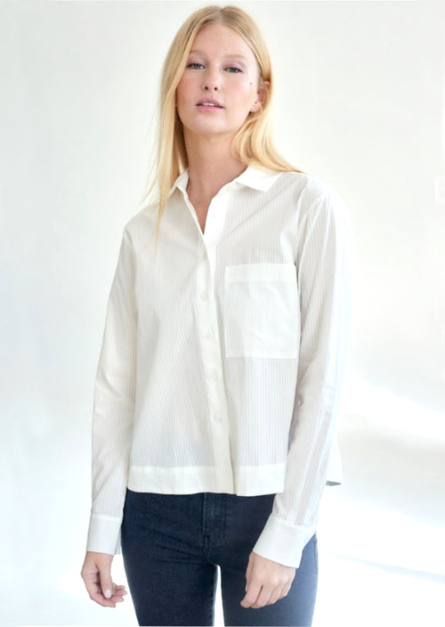 Beautiful blouse with wide cuffed sleeve and button down front - classic white button down. Pleated back adds a bit of flair. 100% Cotton Machine Wash Cold, Tumble Dry Low Made in U.S.A