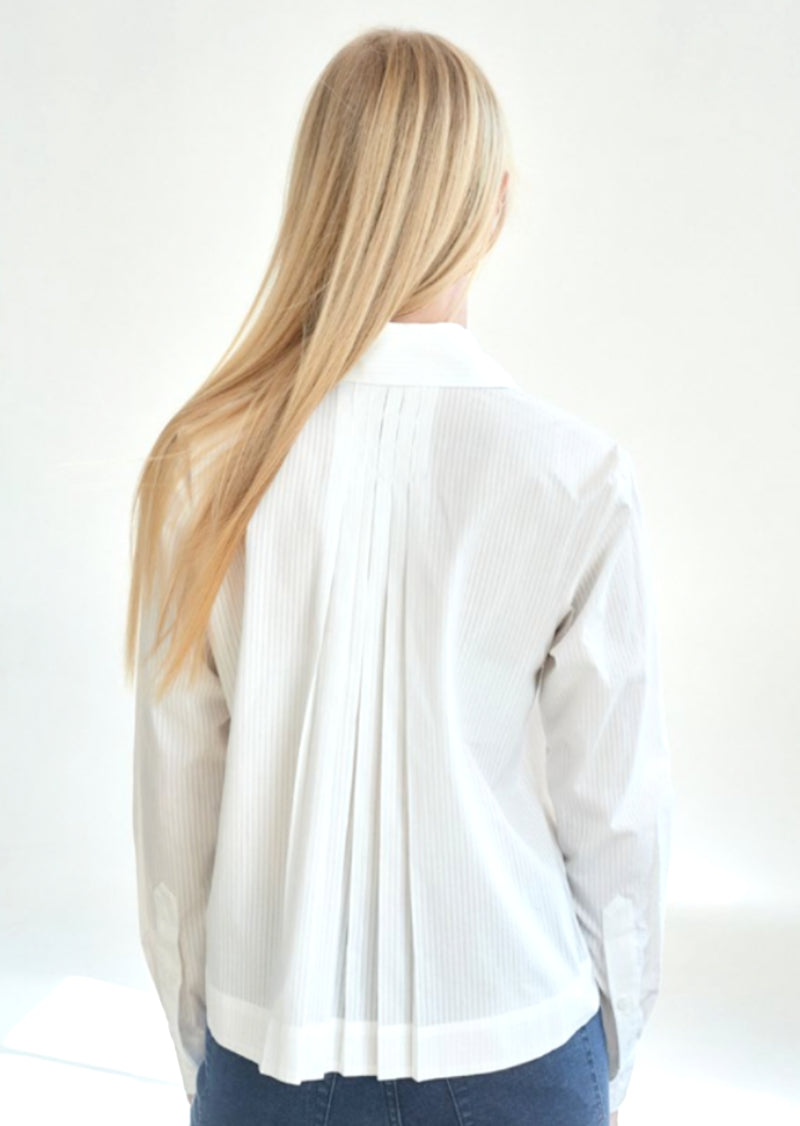 Beautiful blouse with wide cuffed sleeve and button down front - classic white button down. Pleated back adds a bit of flair. 100% Cotton Machine Wash Cold, Tumble Dry Low Made in U.S.A
