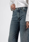 Indulge in the luxurious comfort of these Nine in the Morning Deepa Palazzo Jeans, featuring a soft straight leg design, a mid-rise waist, and a sleek zip and silver plated button fastening. Adorned with a sophisticated logo label on the back, these five-pocket denim jeans exude an air of refinement and comfort.