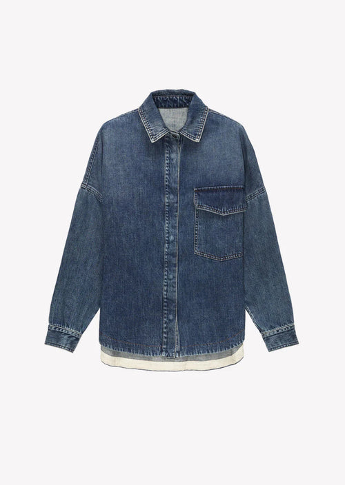 The Rosa Denim Over Shirt features an oversized fit, authentic denim material, and a medium wash. It also has a front patch pocket and concealed button fastening, along with a logo label on the back.