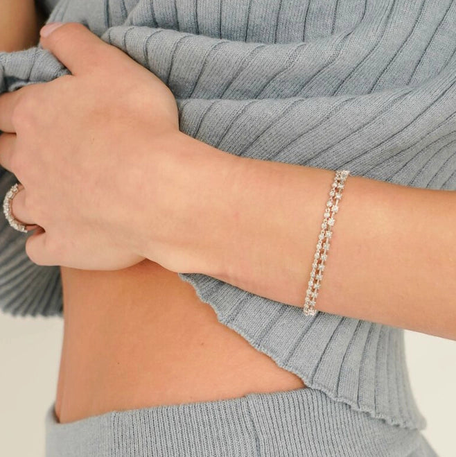 Dana Rebecca bracelet, diamond bracelet, white gold bracelet. diamond tennis bracelet. Meet the diamond station bracelet your jewelry box will almost never see because you'll hardly ever be without it. Just under a half-carat of white round diamonds sparkle in 14k yellow gold intervals. This unique diamond bracelet is a fresh take on the classic diamond tennis bracelet will take you from every outfit and occasion to the next seamlessly. 