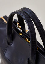 Cornelian Taurus Keyhole Mini in Black. 10" w x 7" h x 4"d Outer: 100% Cow Leather Linning: 100% Cotton Made in Japan Mini shoulder bag that can protect the contents with a flap cover. A bag with a flap cover design looks beautiful, but it takes time and effort to open the bag, which is inconvenient in terms of usability. In order to eliminate this inconvenience, a zipper is attached to the top of the bag to make opening and closing smoother and eliminate stress.