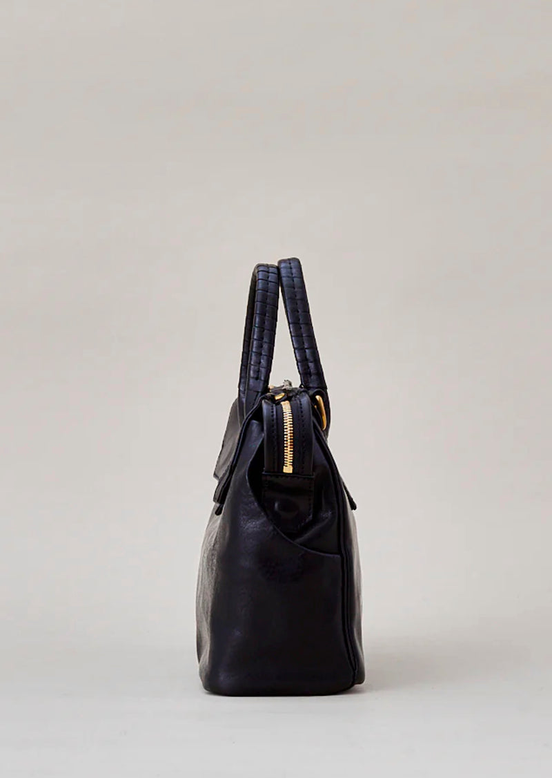 Cornelian Taurus Keyhole Mini in Black. 10" w x 7" h x 4"d Outer: 100% Cow Leather Linning: 100% Cotton Made in Japan Mini shoulder bag that can protect the contents with a flap cover. A bag with a flap cover design looks beautiful, but it takes time and effort to open the bag, which is inconvenient in terms of usability. In order to eliminate this inconvenience, a zipper is attached to the top of the bag to make opening and closing smoother and eliminate stress.