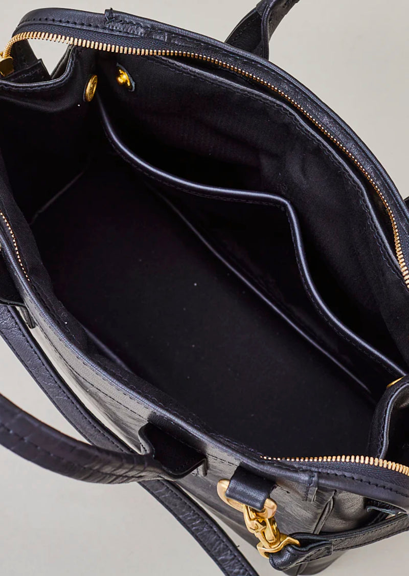 Cornelian Taurus Keyhole Mini in Black. 10" w x 7" h x 4"d Outer: 100% Cow Leather Linning: 100% Cotton Made in Japan Mini shoulder bag that can protect the contents with a flap cover. A bag with a flap cover design looks beautiful, but it takes time and effort to open the bag, which is inconvenient in terms of usability. In order to eliminate this inconvenience, a zipper is attached to the top of the bag to make opening and closing smoother and eliminate stress.