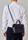 Cornelian Taurus Keyhole Mini in Black. 10" w x 7" h x 4"d Outer: 100% Cow Leather Linning: 100% Cotton Made in Japan Mini shoulder bag that can protect the contents with a flap cover. A bag with a flap cover design looks beautiful, but it takes time and effort to open the bag, which is inconvenient in terms of usability. In order to eliminate this inconvenience, a zipper is attached to the top of the bag to make opening and closing smoother and eliminate stress.