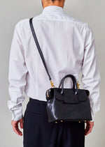 Cornelian Taurus Keyhole Mini in Black. 10" w x 7" h x 4"d Outer: 100% Cow Leather Linning: 100% Cotton Made in Japan Mini shoulder bag that can protect the contents with a flap cover. A bag with a flap cover design looks beautiful, but it takes time and effort to open the bag, which is inconvenient in terms of usability. In order to eliminate this inconvenience, a zipper is attached to the top of the bag to make opening and closing smoother and eliminate stress.