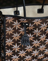 Desmalter Griffon Medium Tote Bag - Handpainted. The Lion’s Paw strap crosses from the traditional Desmalter armchairs which featured a winged lion and seven pointed star, all political and religious symbols, featured in their collection. This is sure to be your go to bag - their structured leather tote is lined in a pop of green.