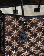 Desmalter Griffon Medium Tote Bag - Handpainted. The Lion’s Paw strap crosses from the traditional Desmalter armchairs which featured a winged lion and seven pointed star, all political and religious symbols, featured in their collection. This is sure to be your go to bag - their structured leather tote is lined in a pop of green.