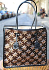 Desmalter Griffon Medium Tote Bag - Handpainted. The Lion’s Paw strap crosses from the traditional Desmalter armchairs which featured a winged lion and seven pointed star, all political and religious symbols, featured in their collection. This is sure to be your go to bag - their structured leather tote is lined in a pop of green.