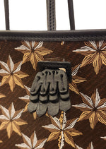 Desmalter Griffon Medium Tote Bag - Handpainted. The Lion’s Paw strap crosses from the traditional Desmalter armchairs which featured a winged lion and seven pointed star, all political and religious symbols, featured in their collection. This is sure to be your go to bag - their structured leather tote is lined in a pop of green.
