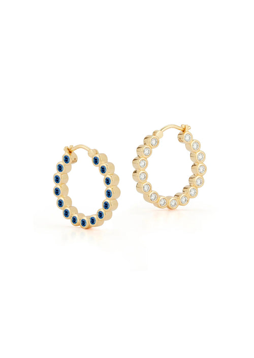Two earrings in one. Bubble diamonds border one side while sapphires sparkle opposite. These 20mm hoop earrings gleam from any perspective. Approximately .91 carat diamonds and 1.35 carat sapphire.  18k Yellow Gold .91 carat of diamonds and 1.35 carat sapphire 20mm hoop
