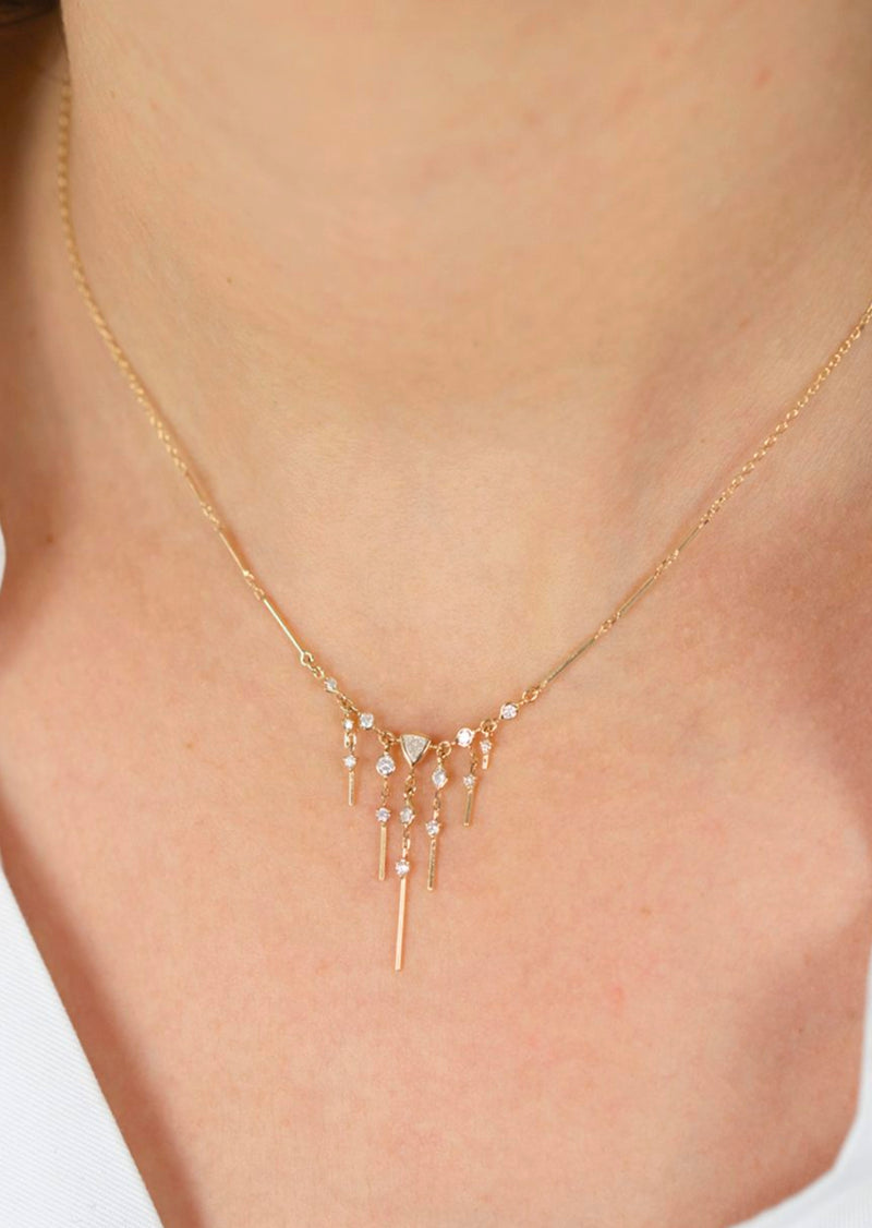 This stunning 14k yellow gold necklace features brilliant marquise diamonds - a gorgeous pendant full of glittering stones. Celine Daoust Dream Maker Triangle & Dangling Diamond Necklace